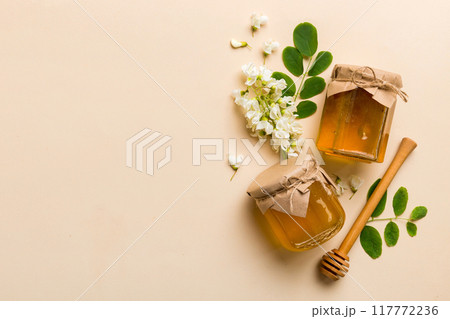 honey jar with acacia flowers and leaves. fresh honey top view flat lay 117772236