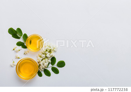 honey jar with acacia flowers and leaves. fresh honey top view flat lay honey jar with acacia flowers and leaves. fresh honey top view flat lay 117772238