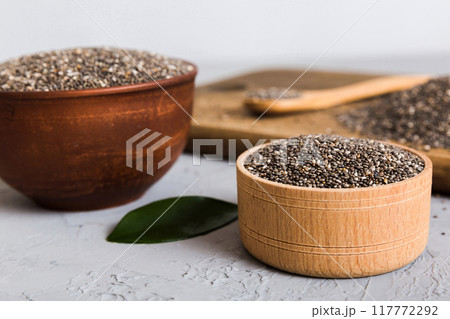 Chia seeds in bowl and spoon on colored background. Healthy Salvia hispanica in small bowl. Healthy superfood 117772292