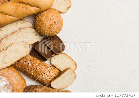 Homemade natural breads. Different kinds of fresh bread as background, top view with copy space Homemade natural breads. Different kinds of fresh bread as background, top view with copy space 117772417