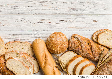Homemade natural breads. Different kinds of fresh bread as background, top view with copy space Homemade natural breads. Different kinds of fresh bread as background, top view with copy space 117772418