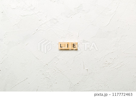 LIE word written on wood block. LIE text on cement table for your desing, concept 117772463