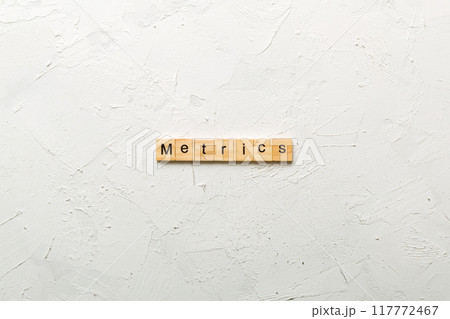 METRICS word written on wood block. METRICS text on cement table for your desing, concept 117772467