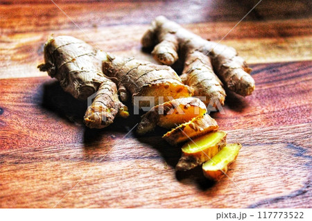fresh turmeric on wooden background 117773522