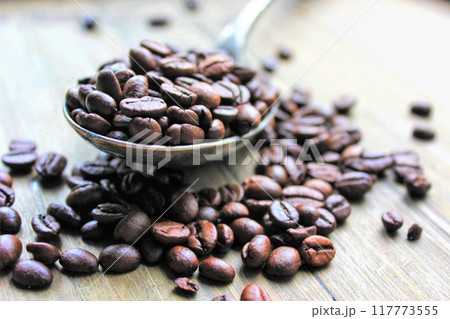 roasted coffee beans in a wooden bowl roasted coffee beans in a wooden bowl 117773555