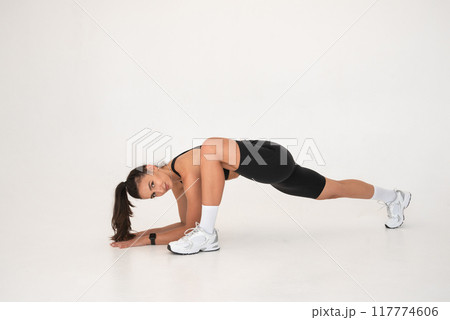 Smiling healthy woman doing yoga at home. white background Smiling healthy woman doing yoga at home. white background 117774606