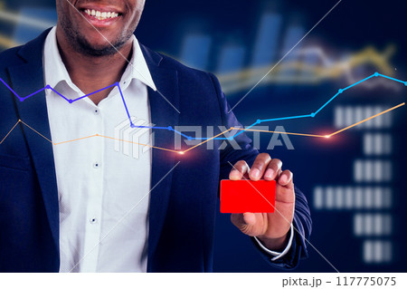A man in a suit holding a red card with a smile on his face A man in a suit holding a red card with a smile on his face 117775075