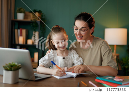 Girl doing homework or online education. Girl doing homework or online education. 117775888