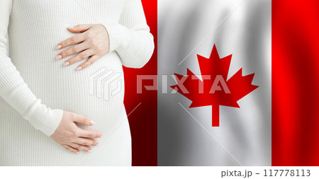 Pregnant woman belly against Canadian flag background. Demographics and pregnancy in Canada concept 117778113