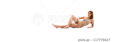 Elegant, beautiful young woman with slim body, posing in underwear on floor isolated on white background 117778827