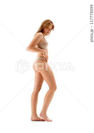 Full-length image of young attractive slim woman posing in underwear , showing her sportive, fit body, isolated on white background Full-length image of young attractive slim woman posing in underwear , showing her sportive, fit body, isolated on white background 117778899