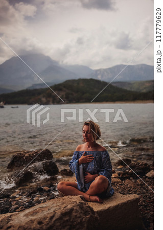 Woman's hands on her chest while doing breathing exercises Woman's hands on her chest while doing breathing exercises 117779629