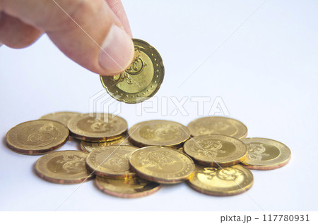 Hand holding golden coins with customizable space for text or ideas. Wealth and copy space concept 117780931