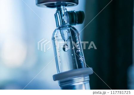 Close up medical intravenous IV drip in hospital background 117781725