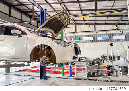 White car in car service centre auto repair workshop 117781729