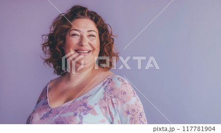 Happiness. Cheerful plump woman laughing and posing standing on purple studio background. 117781904