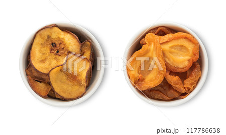 Bowl plates with dried sweet organic pear pieces isolated on white background. 117786638