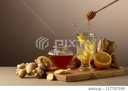 Ginger tea with lemon and honey on a beige background. Ginger tea with lemon and honey on a beige background. 117787589