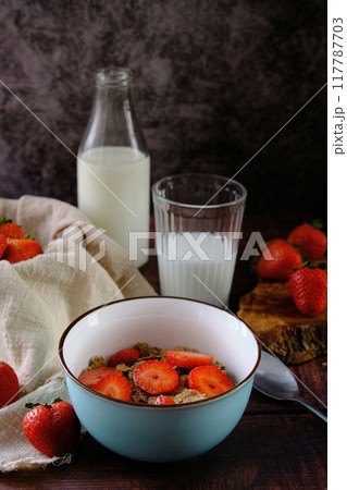 still life bowl of red ripe strawberries on a dark background 117787703