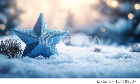 A sparkling blue star ornament surrounded by pinecones in a snowy winter landscape at dusk 117788537
