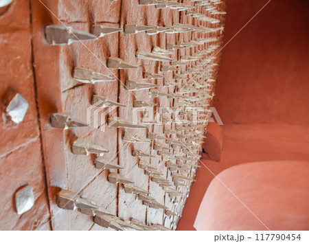 Red spiked iron main gate at Junagarh Fort in Bikaner 117790454