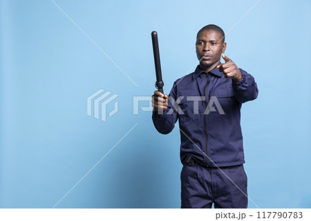 Mall security guard holds a baton pointing at...の写真素材 [117790783] - PIXTA