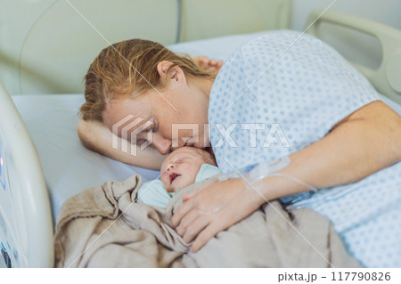 A baby lies with the mother after childbirth, resting peacefully. The serene moment captures the bond between mother and child as they begin their journey together. The hospital environment ensures a 117790826