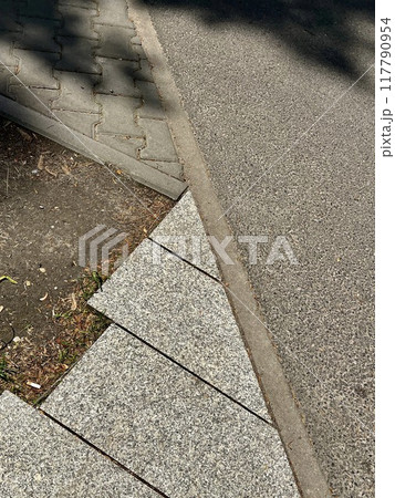 Stone walkway with shadow on the ground in the city park. Stone walkway with shadow on the ground in the city park. 117790954