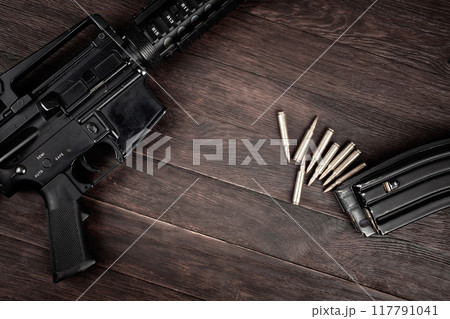 Rifle and Ammunition with magazine on wooden table 117791041