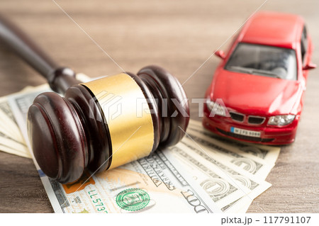 Hammer gavel judge and US dollar banknote money with car vehicle accident, insurance coverage claim lawsuit court case. Hammer gavel judge and US dollar banknote money with car vehicle accident, insurance coverage claim lawsuit court case. 117791107
