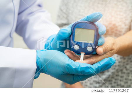 Doctor check diabetes from finger blood sugar level with finger lancet. 117791267