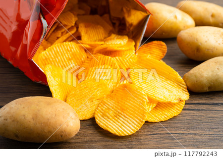 Potato chips, delicious BBQ seasoning spicy for crips, thin slice deep fried snack fast food in open bag. 117792243