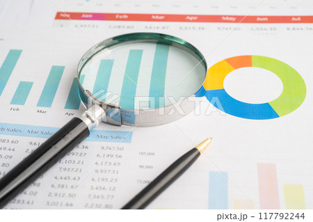Magnifying glass on spreadsheet and graph paper. Financial development, Banking Account, Statistic, Investment Analytic research data economy, Business. Magnifying glass on spreadsheet and graph paper. Financial development, Banking Account, Statistic, Investment Analytic research data economy, Business. 117792244