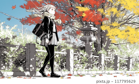 紅葉の小径を歩く若い女性