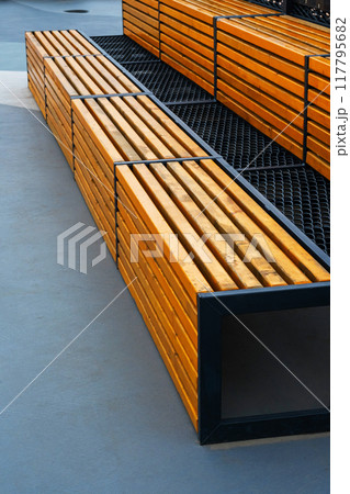 Modern wooden benches on the outdoor basketball court. 117795682