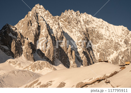 Beautiful view of Jade Dragon Snow Mountain (or Mt.Yulong) during sunrise. This mountains located in Yulong Naxi Autonomous County, Lijiang, in Yunnan province, China. Beautiful view of Jade Dragon Snow Mountain (or Mt.Yulong) during sunrise. This mountains located in Yulong Naxi Autonomous County, Lijiang, in Yunnan province, China. 117795911