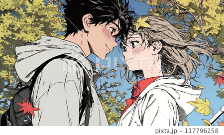 紅葉の下でいちゃついている若いカップル