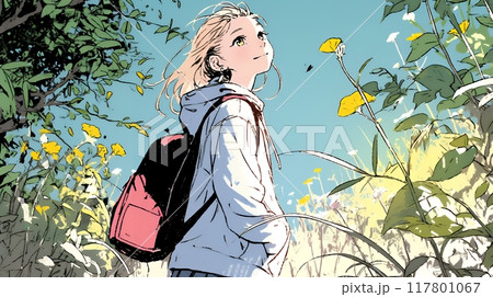 秋の野山をハイキングしている若い女性
