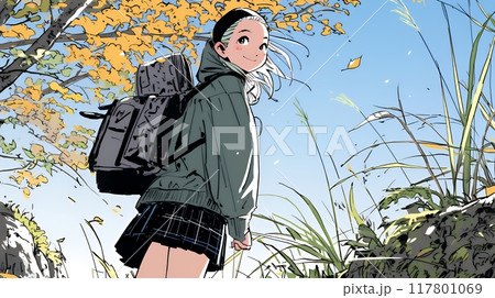 秋の野山をハイキングしている若い女性