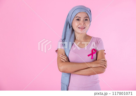 a asian woman in with pink breast cancer awareness ribbon isolated on pink blank copy space studio background,healthcare,medicine concept 117801071