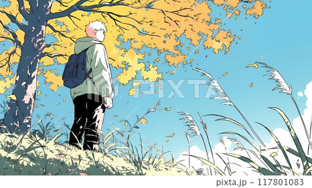 秋の野山をハイキングしている若い男性