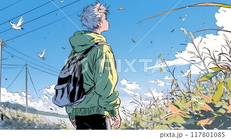 秋の野山をハイキングしている若い男性