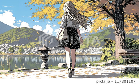 水辺の紅葉の小径を散策している若い女性