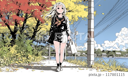 水辺の紅葉の小径を散策している若い女性