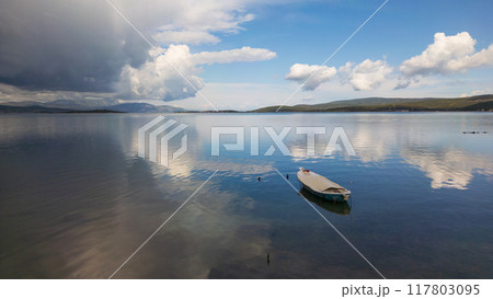 A small boat at beach of Urla, izmir. beautiful clouds 117803095