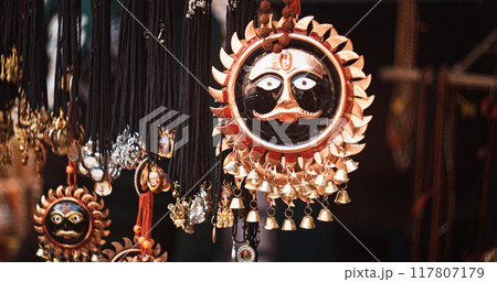 Hindu God Shanidev or Bhagwaan Shani Ji souvenirs. Traditional Indian street shop of religious portraits, souvenirs, Hinduism symbols in outdoor market of India 117807179