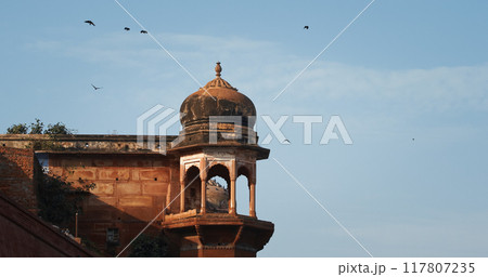 Varanasi, Uttar Pradesh, India. Crows Fly Above Chet Singh Fort, Jain Ghat. Clear Blue Sky. Flight Varanasi, Uttar Pradesh, India. Crows Fly Above Chet Singh Fort, Jain Ghat. Clear Blue Sky. Flight 117807235