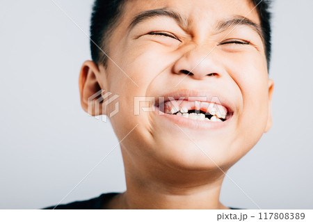 Boy grins missing upper tooth gap evident. Child dental growth isolated on white. Joyful tooth fairy moment. Children show teeth new gap, dentist problems. little boy no tooth Boy grins missing upper tooth gap evident. Child dental growth isolated on white. Joyful tooth fairy moment. Children show teeth new gap, dentist problems. little boy no tooth 117808389