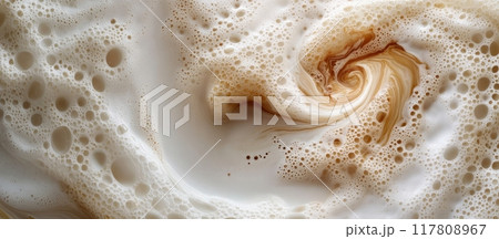 Close-Up of Swirling Coffee Foam with Bubbles Creating a Hypnotic Pattern in a Creamy Beverage 117808967