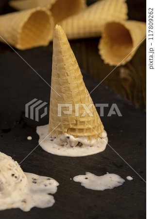creamy ice cream with pieces of chocolate on a black slate creamy ice cream with pieces of chocolate on a black slate 117809262
